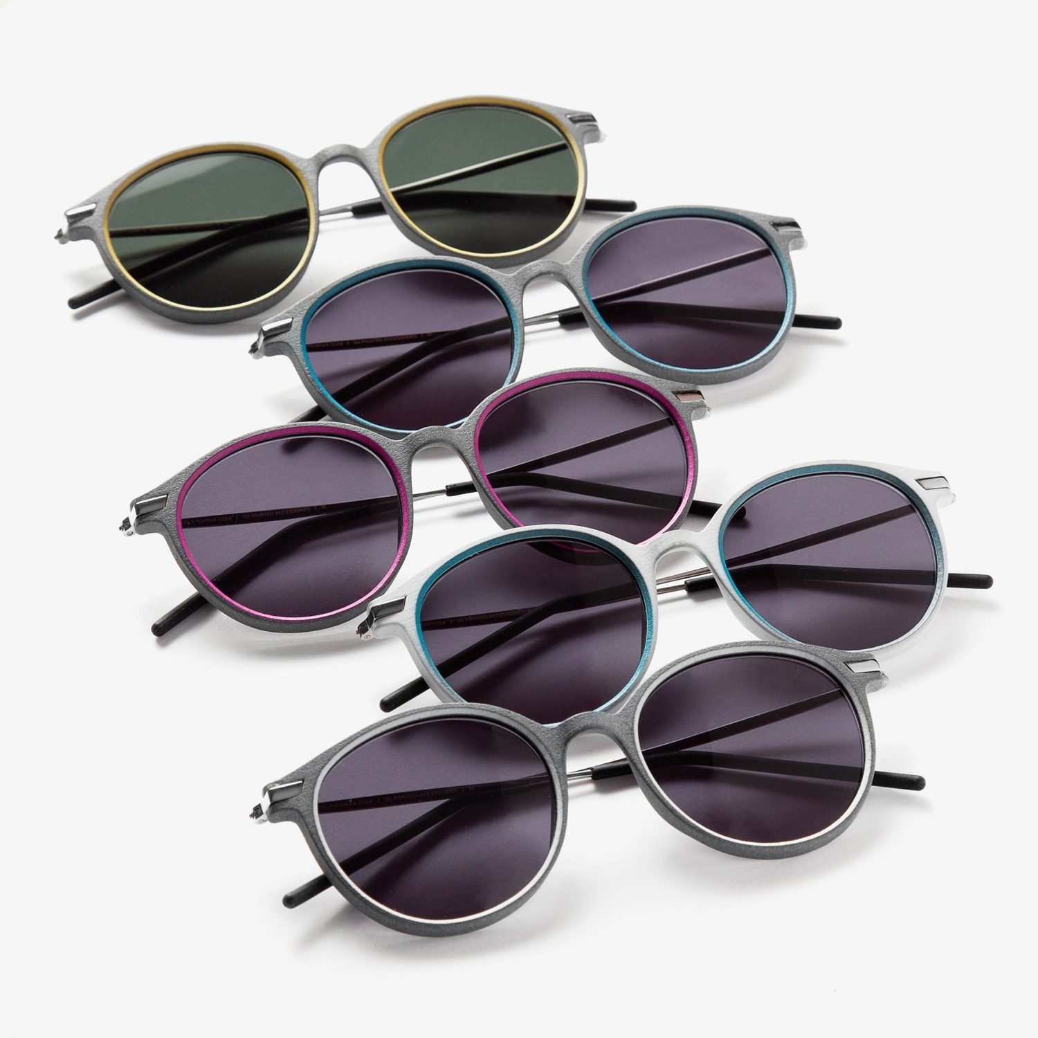 LIQ Eyewear: Five round 3D-printed sunglasses in olive, teal, magenta, white and grey lined up diagonally